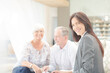 © KOTO - Financial advisor smiling with couple on sofa