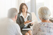 © KOTO - Financial advisor talking to couple on sofa