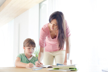 Mother helping daughter with homework