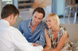 © KOTO - Financial advisor talking to couple on sofa