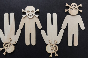 wooden silhouettes with laser cut-scary monster masks and skull and bones on a dark background