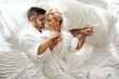 © Dusan Petkovic - Time is just for us, no children. Intimacy is full of passion and love in a hotel room. A beautiful blonde and handsome man wakes up and cuddles on a sunny morning. Lovely sensitive memories in hotel