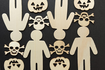 Wall Mural - wooden silhouettes with laser cut-scary monster masks and skull and bones on a dark background