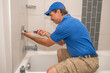 © spatesphoto - Plumber working on tub cartridge