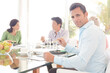 © KOTO - Businessman smiling in lunch meeting