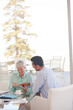 © KOTO - Business people using tablet computer on sofa