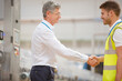 © KOTO - Supervisor and worker shaking hands in factory