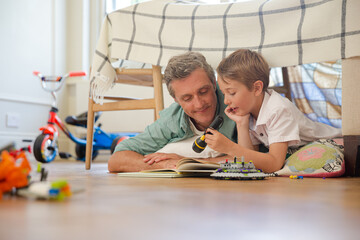 Wall Mural - Father and son reading in bedroom