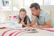 © KOTO - Father helping daughter with homework
