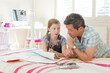 © KOTO - Father helping daughter with homework