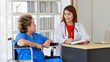 © Bangkok Click Studio - Asian woman doctor writing note and near with elderly female as sitting on wheelchair both of them are smiling look to happy and comfortable at hospital in the morning