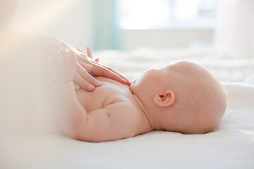 Mother touching baby girl