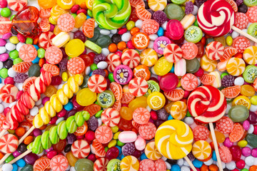 Wall Mural - Colorful lollipops and different colored round candy.