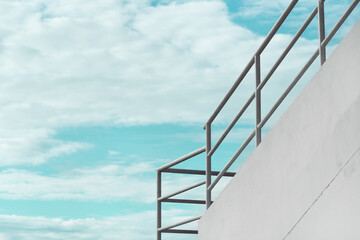 contemporary white cement wall and metal architecture with blue sky background