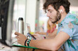 Man listening to mp3 player in cafe