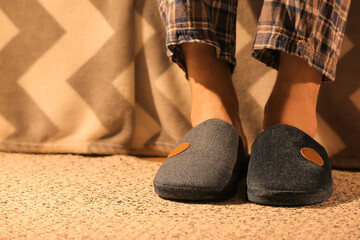 Man wearing soft slippers at home, closeup