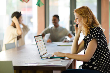 Wall Mural - Woman working at conference table in office