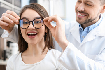 Wall Mural - Woman choosing new eyeglasses at ophthalmologist's office