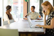 © KOTO - Woman working at conference table in office