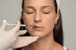 © vladimirfloyd - Portrait of a young satisfied woman on a face filler injection procedure
