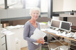 Businesswoman carrying paperwork in office