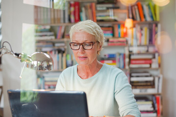 Wall Mural - Businesswoman smiling at computer in home office