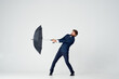 © SHOTPRIME STUDIO - man in suit holding an umbrella in his hands elegant style weather rain