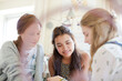 © KOTO - Three teenage girls relaxing in bedroom
