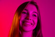 © Lustre Art Group  - Close-up portrait of young caucasian beautiful girl attractively smiling on gradient pink background