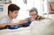 © KOTO - Two teenage boys using electronic devices in room