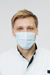 © arthurhidden - Portrait of a young male medical doctor wear sterile mask isolated on white background