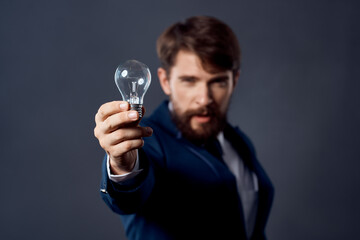 man in a suit with a lamp in his hands idea of success emotions