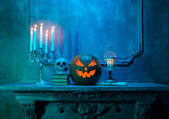 Canvas Print - Scary laughing pumpkin and old skull on ancient gothic fireplace. Halloween, witchcraft and magic.