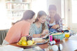 © KOTO - Teenage girls learning at table in kitchen