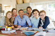 © KOTO - Group of teenagers with mid adult man sitting at table in dining room