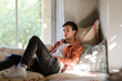 Teenage boy lying on sofa and thinking