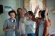 © KOTO - Group of teenagers dancing in living room