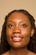© Phiwo Ndlovu/Cultura Creative - Studio portrait of smiling woman with braided hair