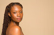 © Phiwo Ndlovu/Cultura Creative - Studio portrait of shirtless woman with braided hair