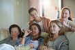 © KOTO - Group of teenagers having fun while watching tv on sofa