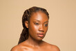 © Phiwo Ndlovu/Cultura Creative - Studio portrait of shirtless woman with braided hair