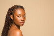 © Phiwo Ndlovu/Cultura Creative - Studio portrait of shirtless woman with braided hair
