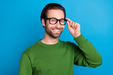 Poster - Photo of young handsome positive businessman freelancer wear spectacles green pullover isolated on blue color background