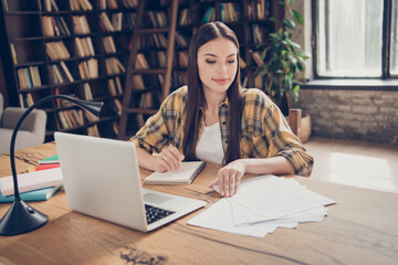 Sticker - Photo of young beautiful peaceful focused girl university student prepare for exam test reading documents study with laptop indoors