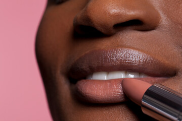 Wall Mural - Young woman applying lipstick