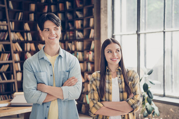 Poster - Photo of two cheerful smiling thoughtful confident university students with folded arms look sideways thinking brainstorming