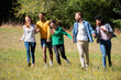 © PhotoAlto - Happy young friends walking together in public park