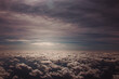 Sunlight between layers of thick clouds in the sky - view from an airplane - heaven concept