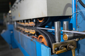 Fiber optic cable production machine, line in a factory in a workshop. Production of fiber optic and fiberglass cables for telecommunications.