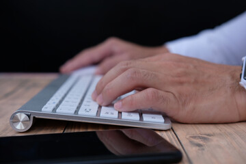 Poster - Businessman working on computer in office, closed up typing keyboard
